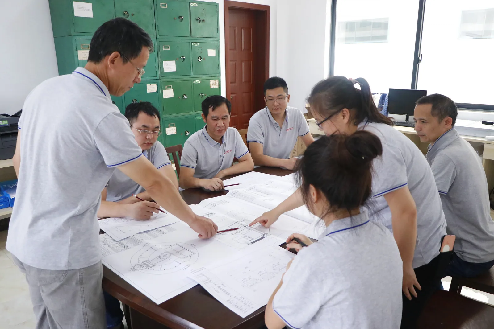 Cronus engineering team reviewing crusher drawings